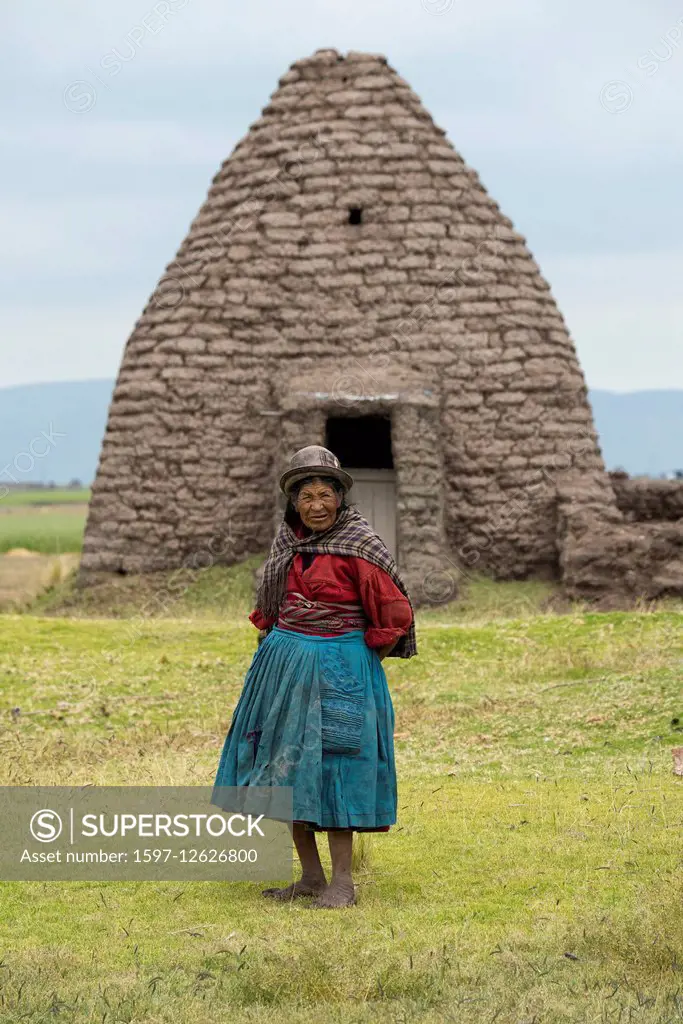 round adobe barn and native indo woman in Peru