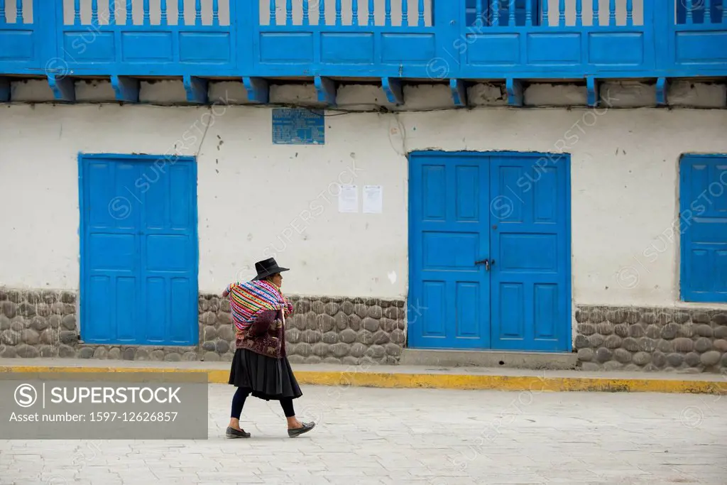 native woman walking in town square of Ajanaco, Peru