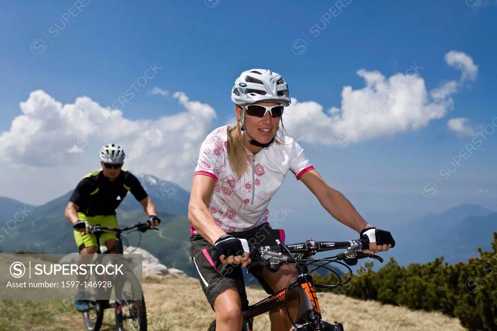 Mountainbiking, woman, mountains, bike, man, go, biking, sport, extreme sport, blue, sky, action, Monte Baldo, lake Garda, South Tirol, Italy,