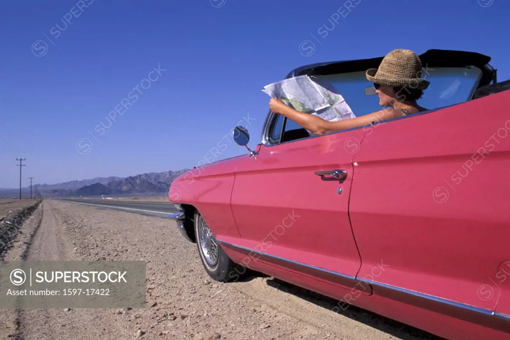 California, Girl, woman, 1962 Pink Cadillac Convertible, reading, map, Mojave Desert, Old Route 66, USA, America, Un