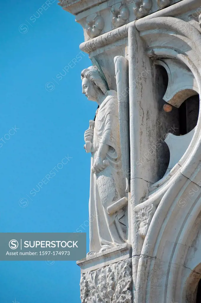 Sculpture of a woman representing justice carrying a scroll of law on the eastern corner of the Doge´s Palace in Venice, Italy