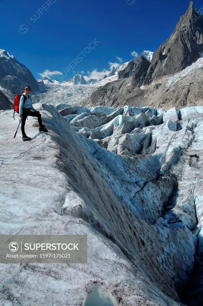 A woman climber considers her options crossing a crevasse field on the ´sea of ice´ or mer de glace in the mont blanc massif above Chamonix, France