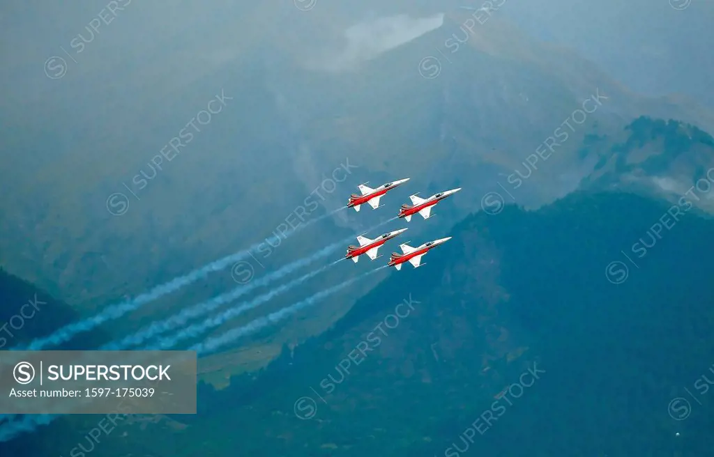 SION, SWITZERLAND, Swiss airforce team trailing smoke in the mountains at the Breitling Air show. September 17, 2011 in Sion, Switzerland