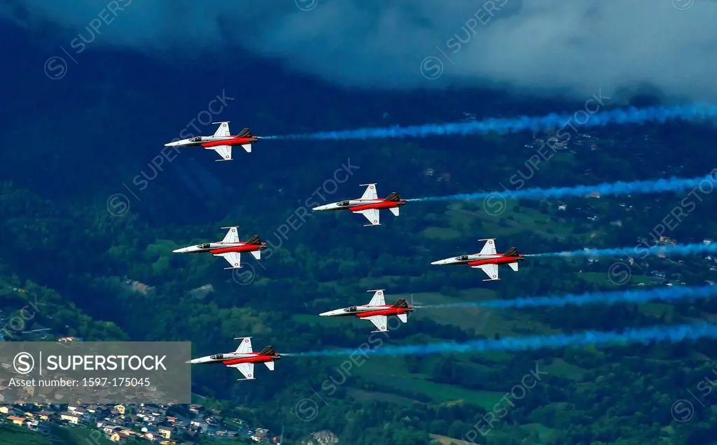 SION, SWITZERLAND, Swiss airforce team in formation over the alps at the Breitling Air show. September 18, 2011 in Sion, Switzerland