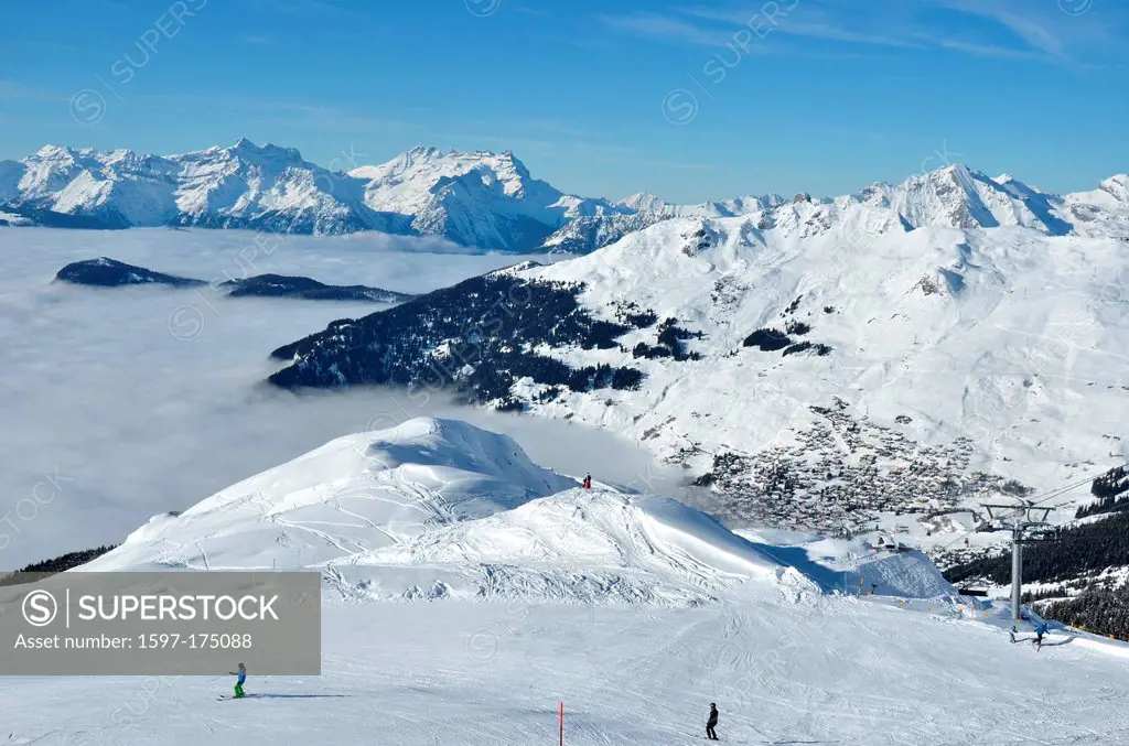 the famous winter ski resort of Verbier in the Swiss Alps. In the background The Dents du Midi, in the foreground skiers and fresh snow.