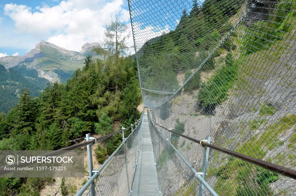 A steel suspension in the mountains for pedestrians, with steel netting to protect them from rock falls.