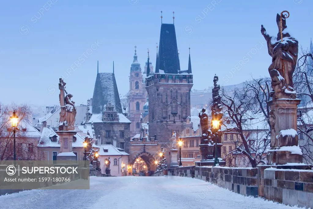 Prague - Charles Bridge tower and St. Nicolas church on winter morning