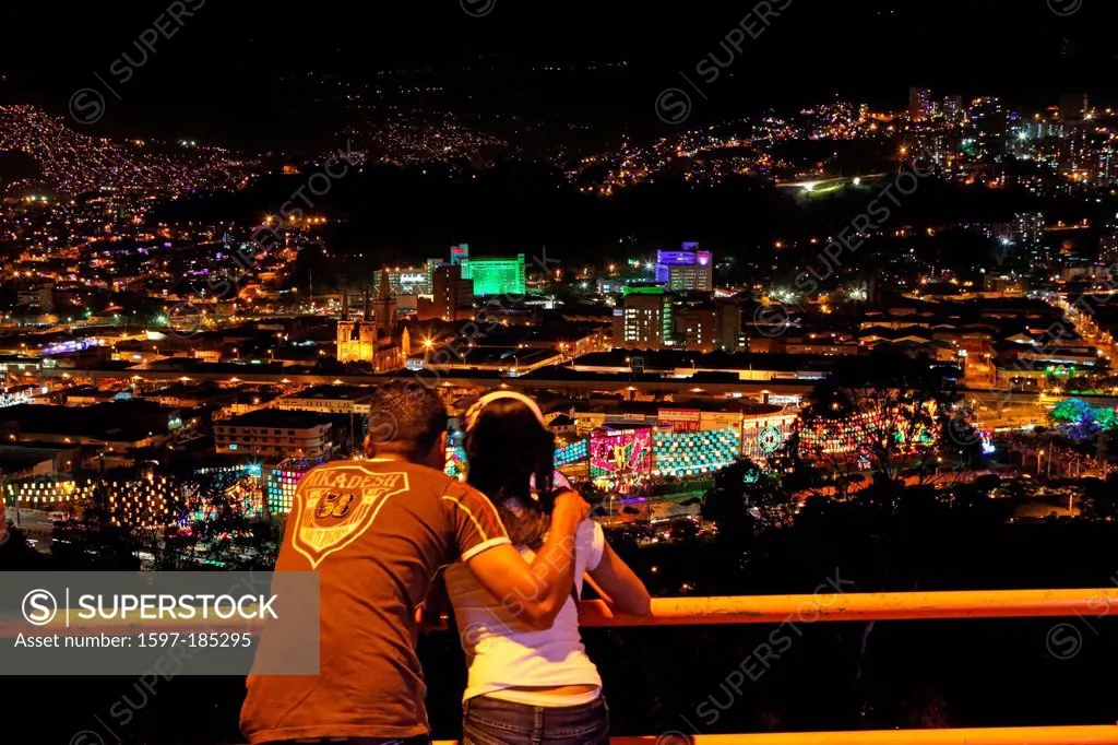 Colombia, South America, Medellin, night, night shot, couple, look, hills, city, lights, town, city, city, embrace, happy, young, Christmas lighting, ...