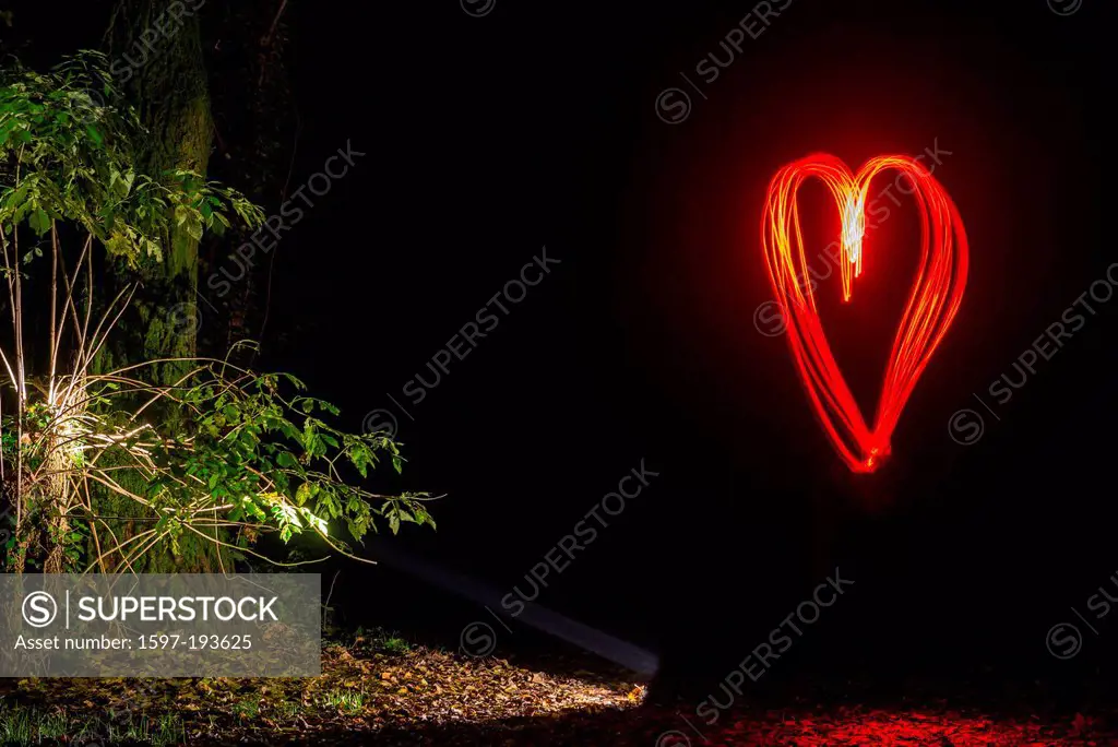 Illuminated heart in the forest in ticino Switzerland, Europe,