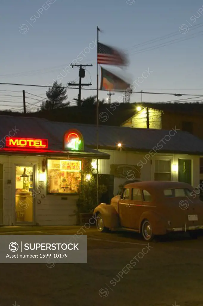 Route 66 neon sign and historic vintage roadside motel welcomes old cars and guests in Barstow California