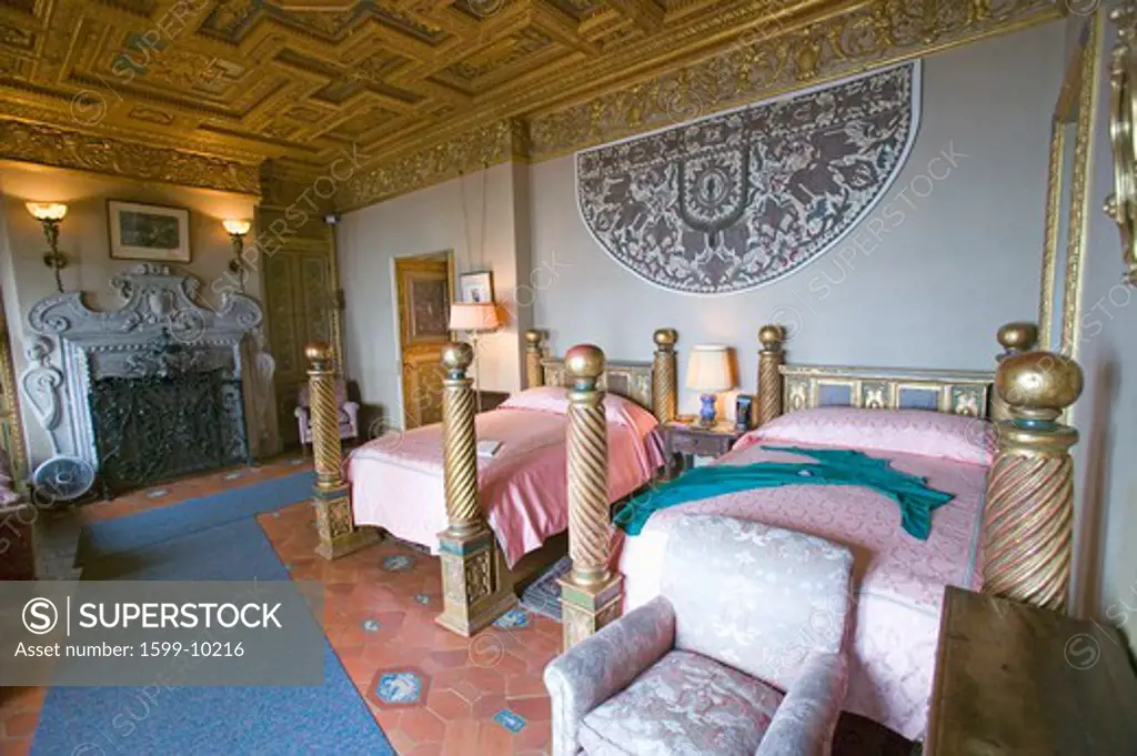 Interior of guest bedroom with displayed antique clothing of the day at Hearst Castle, 'America's Castle,' San Simeon, Central California Coast