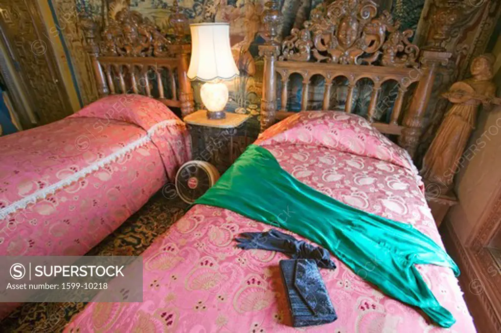 Interior of guest bedroom with displayed antique clothing of the day at Hearst Castle, 'America's Castle,' San Simeon, Central California Coast