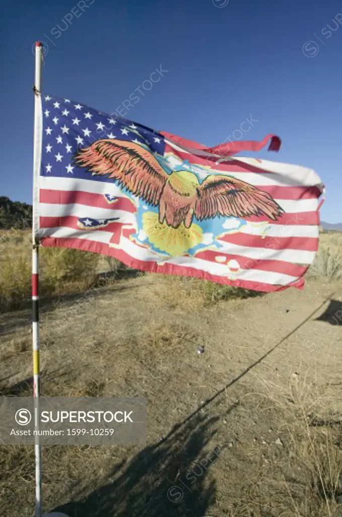 Native American Indian flag blows in wind on Chumash Indian land on highway 33, near Cuyama California