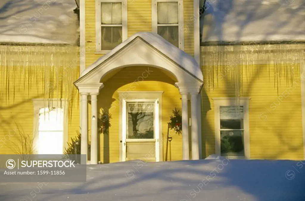 Entrance to yellow home at sunrise in winter,  Lyndonville, VT