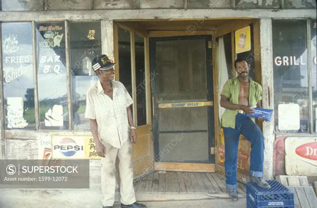 Two African-American men outside a grocery store, Cairo, IL