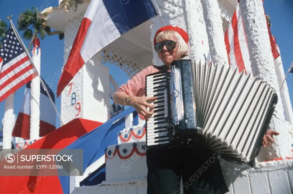 A female accordion player performing at the French Revolution Bicentennial Celebration, Hollywood Park, CA