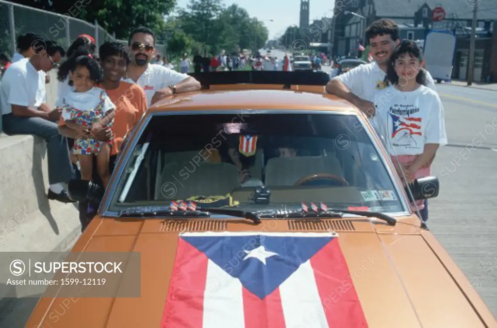 A Puerto Rican family with their flag draped car at the Puerto Rican Festival, Wilmington, DE