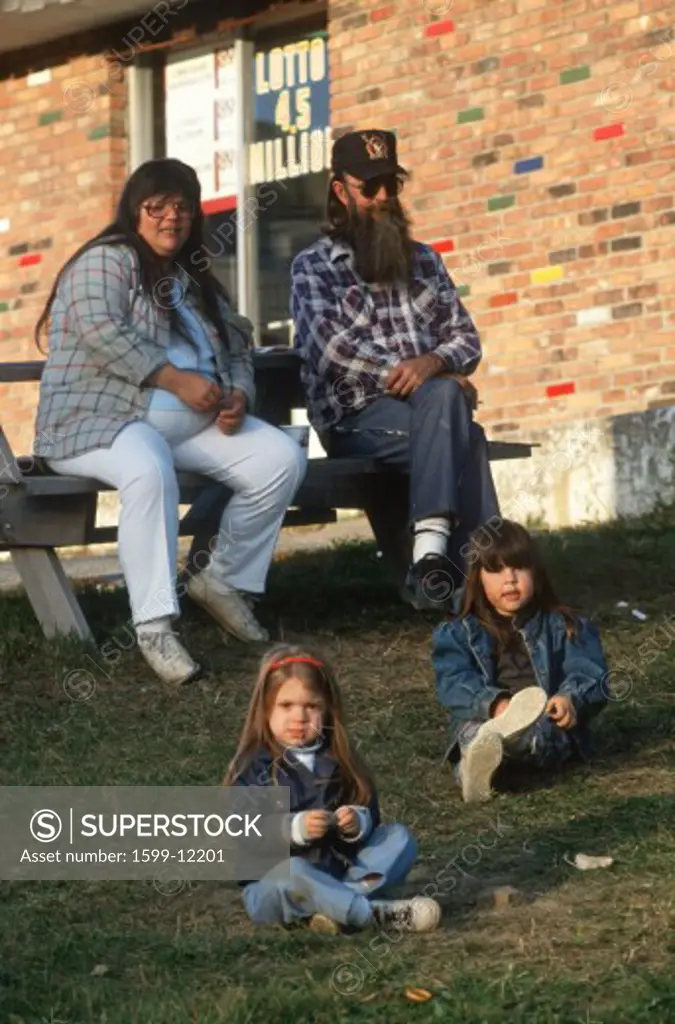 A family of four sitting together in Port Henry, NY