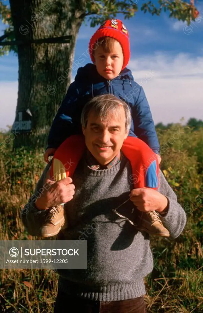 A boy sitting on his grandfather's shoulders, CT