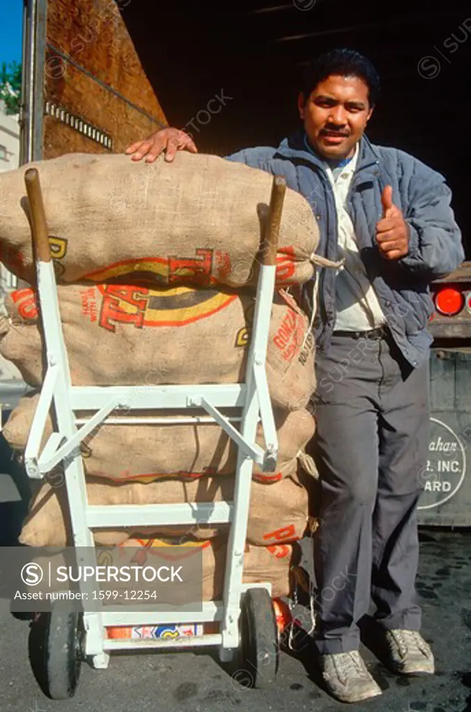 Deliveryman with sacks of potatoes on a dolly, San Francisco, CA