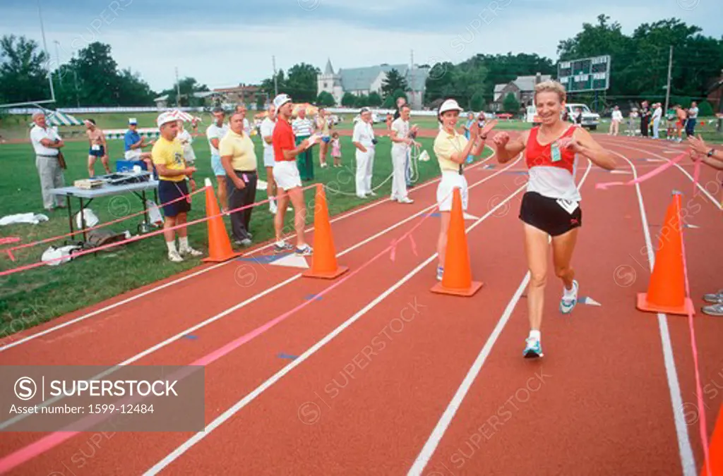 A female runner crossing the finish line at the Senior Olympics, St. Louis, MO