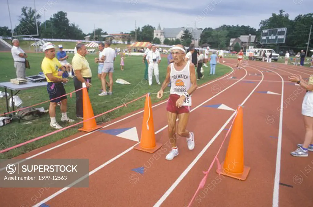 Runner crosses the finishing line at the Senior Olympics, St. Louis, MO