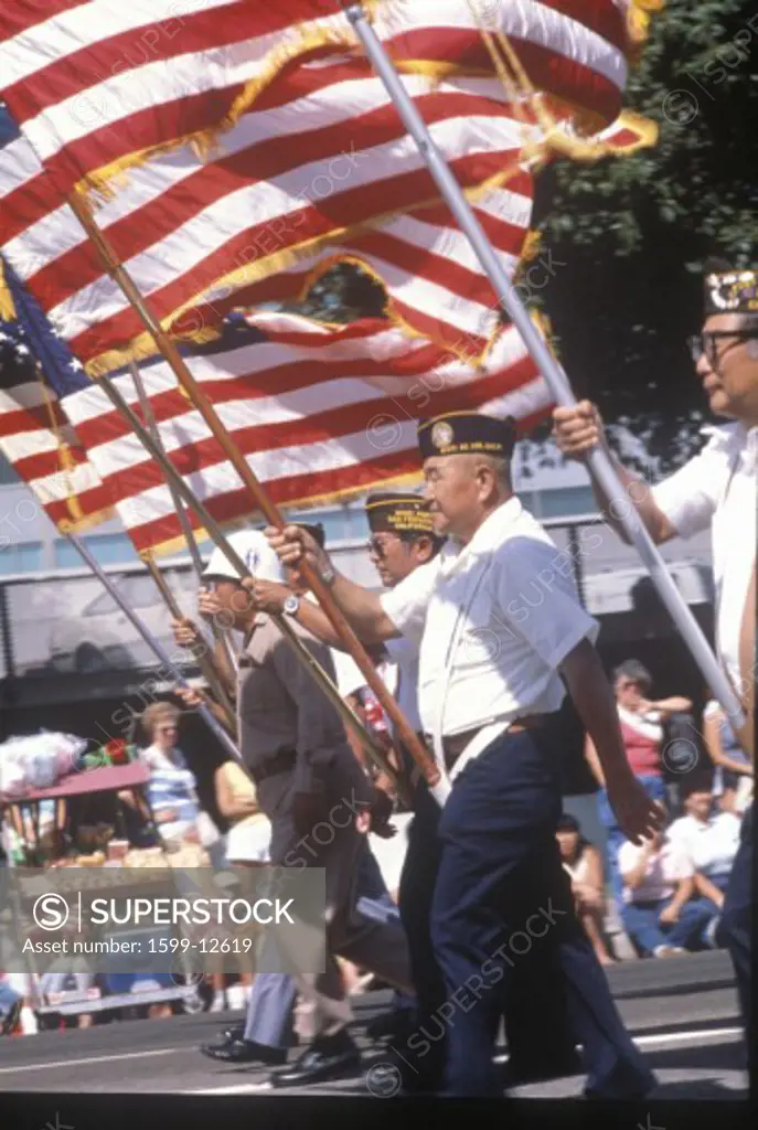 Veterans marching with American Flag in parade