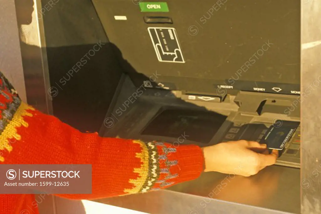 Woman at 24 hour ATM machine, NM