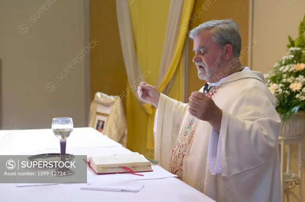 Catholic Priest administers wedding vows and prayers at St. Thomas Catholic Church in Ojai, California