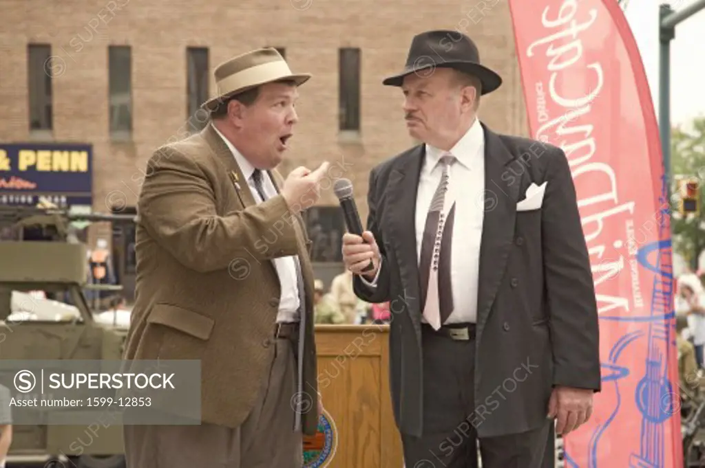 1940s World War II home front comedian actors of Bud Abbott and Lou Costello (played by Bill Riley and Joe Ziegler) telling jokes at Mid-Atlantic Air Museum World War II Weekend and Reenactment in Reading, PA held June 18, 2009