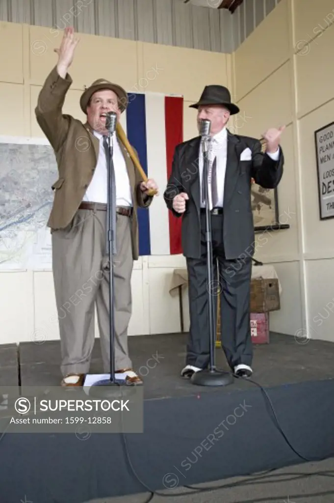 1940s World War II home front comedian actors Bud Abbott and Lou Costello (played by Bill Riley and Joe Ziegler) telling jokes at Mid-Atlantic Air Museum World War II Weekend and Reenactment in Reading, PA held June 18, 2008