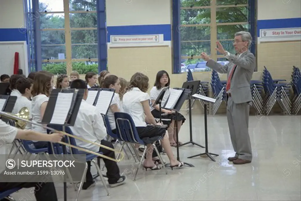 Grade school band conductor leading school 5th grade band recital at Ravensworth Elementary, Fairfax County, Springfield, Virginia