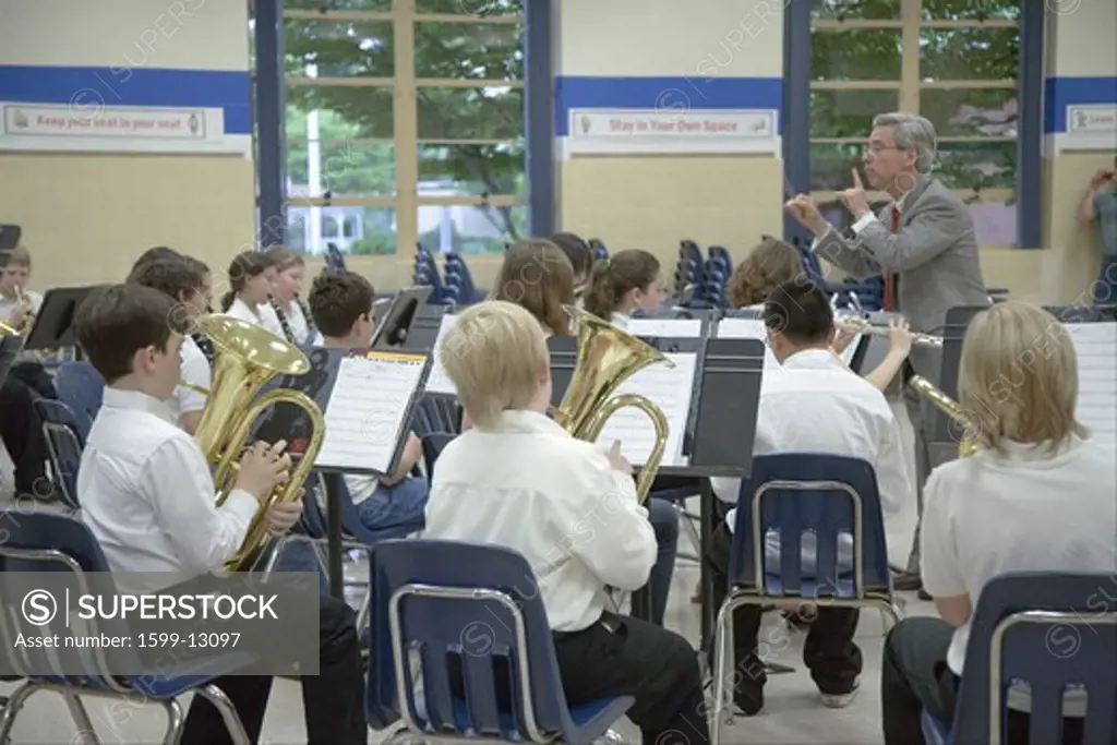 Grade school band conductor leading school 5th grade band recital at Ravensworth Elementary, Fairfax County, Springfield, Virginia