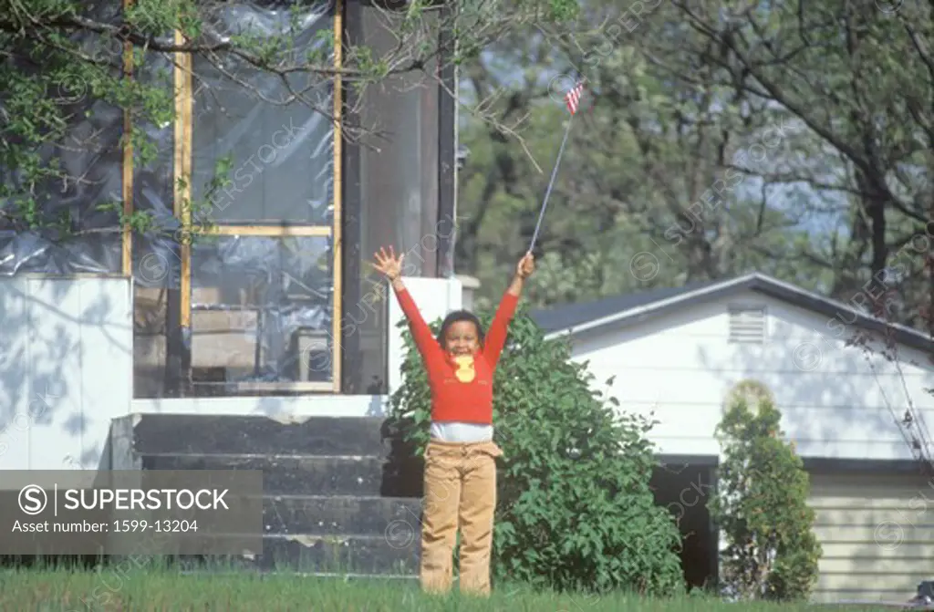 An African-American girl holding an America flag, MN