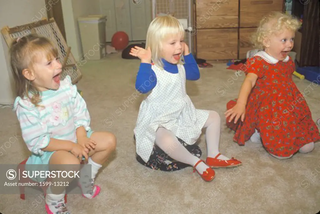 Three preschool girls singing at their daycare center, Washington D.C.