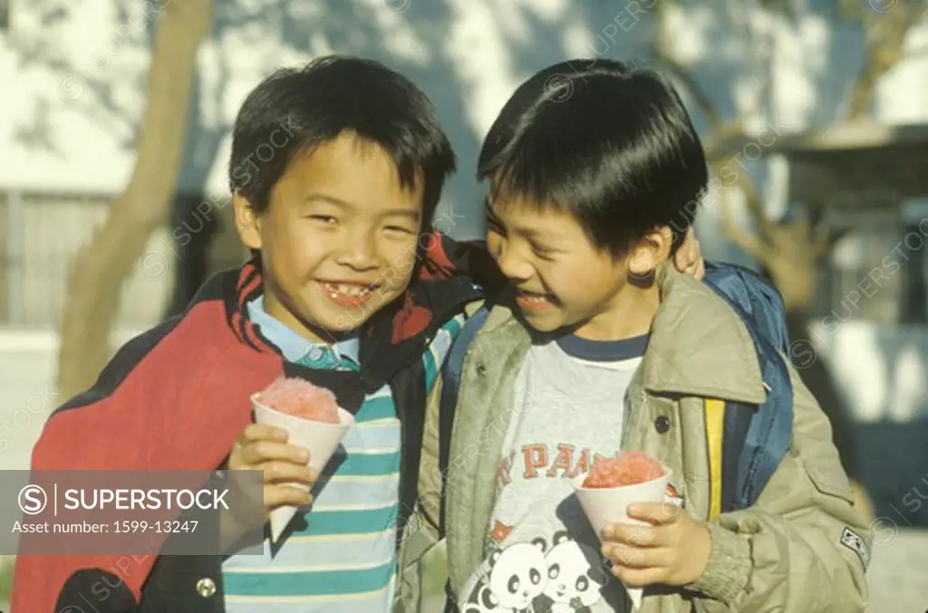 Two Chinese-American boys eating snowcones in Chinatown, Los Angeles, CA