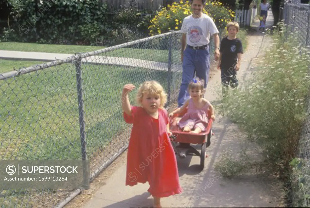 Children in a red wagon, Venice, CA