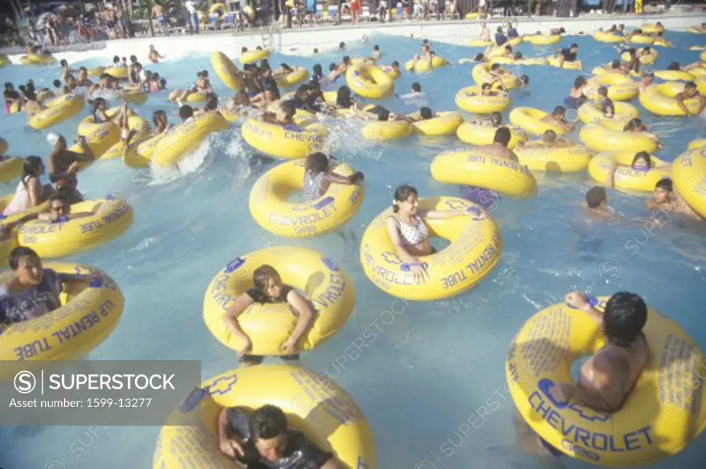 Children in inner tubes floating Raging Waters waterpark,Los Angeles, CA