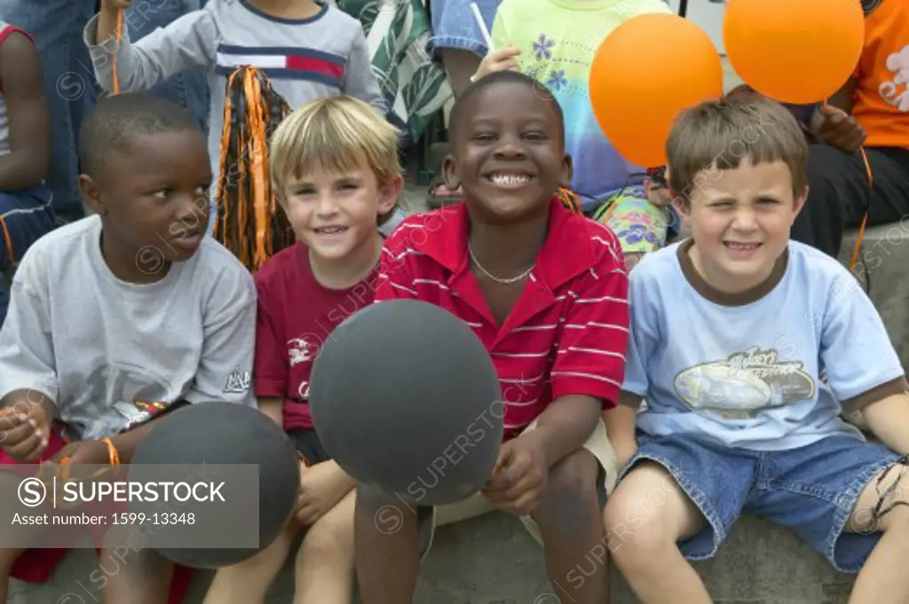 Children smiling and holding balloons at parade in Central GA