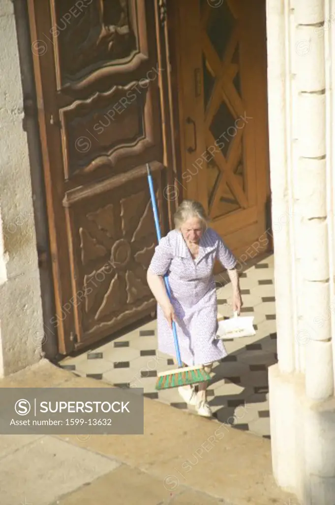 Woman sweeping up after Wedding Party, Antibes, France
