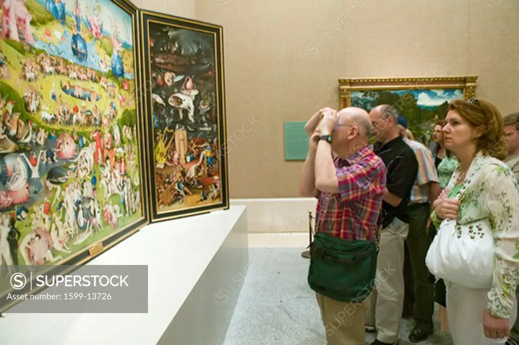 Man photographs 'The Garden of Earthly Delights' by Hieronymus Bosch, in the Museum de Prado, Prado Museum, Madrid, Spain