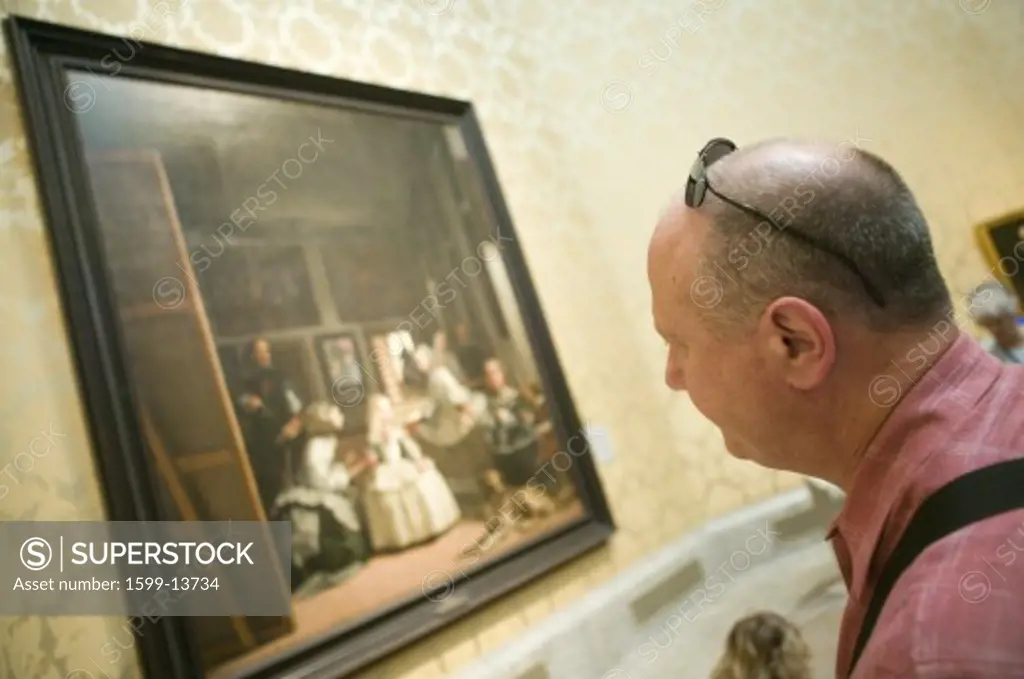 Man looks at Las Meninas by Velazquez as shown in the Museum de Prado, Prado Museum, Madrid, Spain