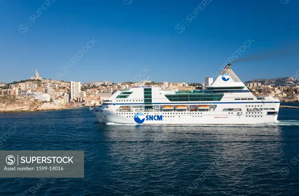 Ferry boat cruising into old port and third largest city in France, Marseille, Provence, France on the Mediterranean Sea