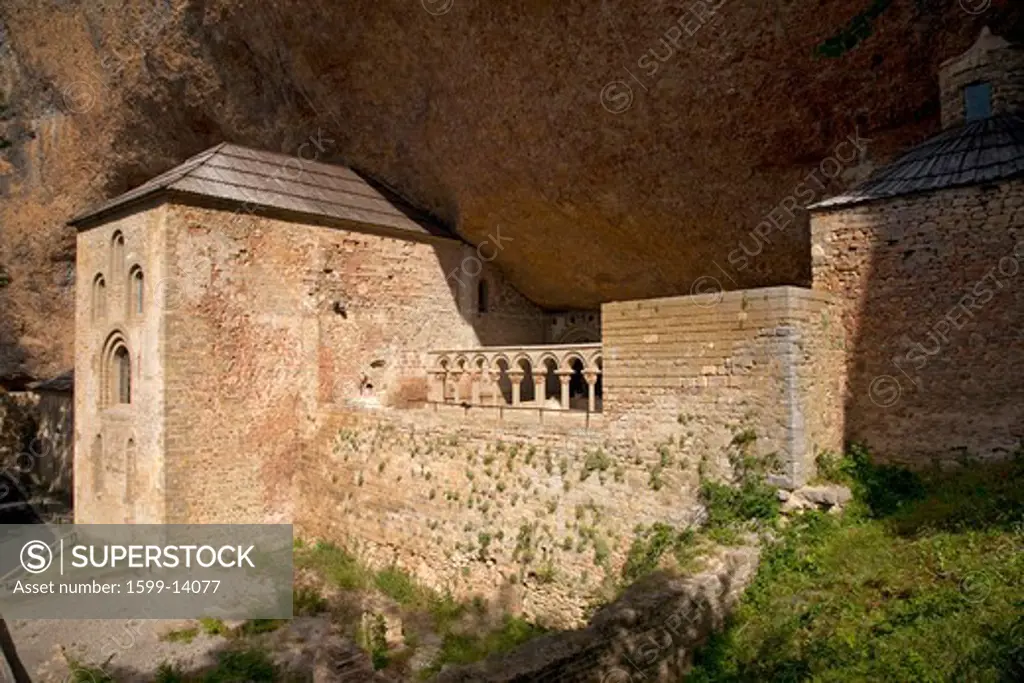 The Monastery of San Juan de la Pena, Jaca, in Jaca, Huesca, Spain, carved from stone under a great cliff.  It was originally built in 920 AD and in 11th Century, became part of Benedictine Order, the site thought to house the legendary Last Supper 'Holy Grail' and associated with the legend of 'Monte Pano