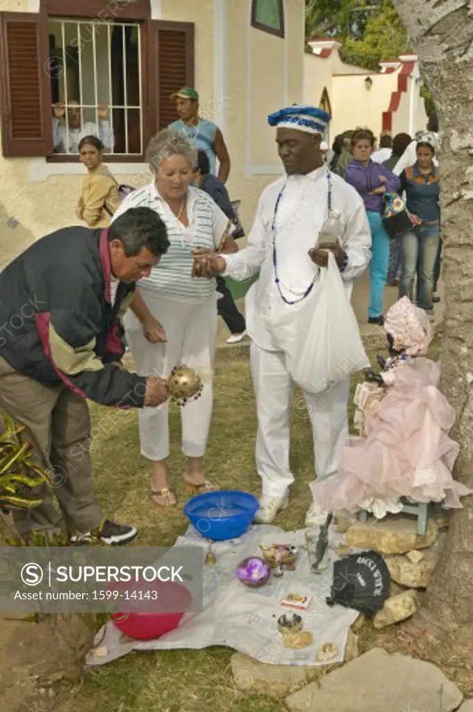 San Lazaro Catholic Church with Santeria priest offering services in El Rincon, Cuba
