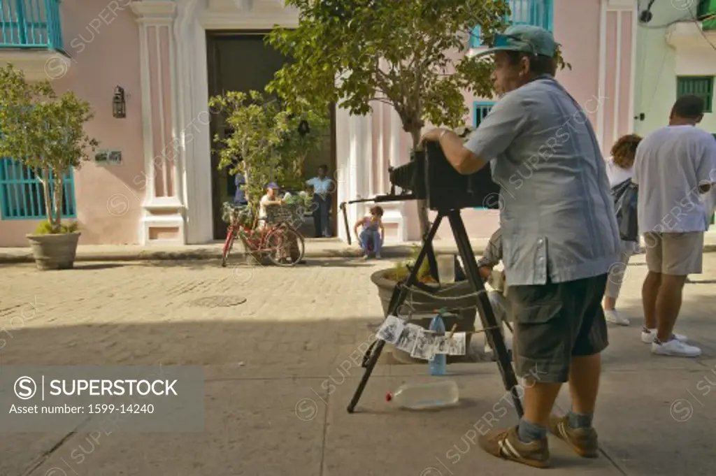 Large format photographer taking pictures in the historic areas of Old Havana, Cuba