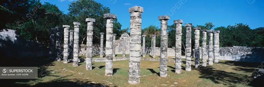 A panoramic view of columns surround grassy courtyard for ballgames at Chichen Itza, Mayan Ruins in the Yucatan Peninsula, Mexico