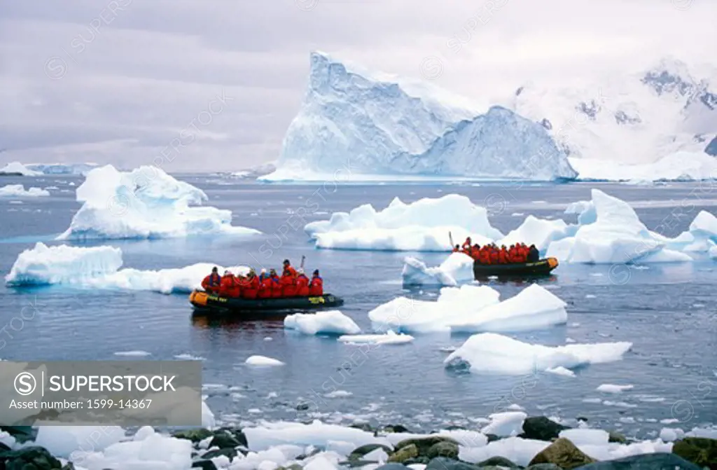 Ecological tourists in inflatable Zodiac boat in Paradise Harbor, Antarctica