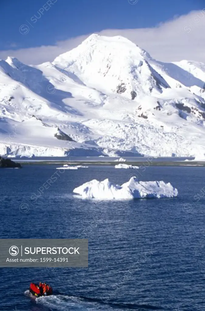 Ecological tourists in inflatable Zodiac boat and glaciers and icebergs near Half Moon Island, Bransfield Strait, Antarctica