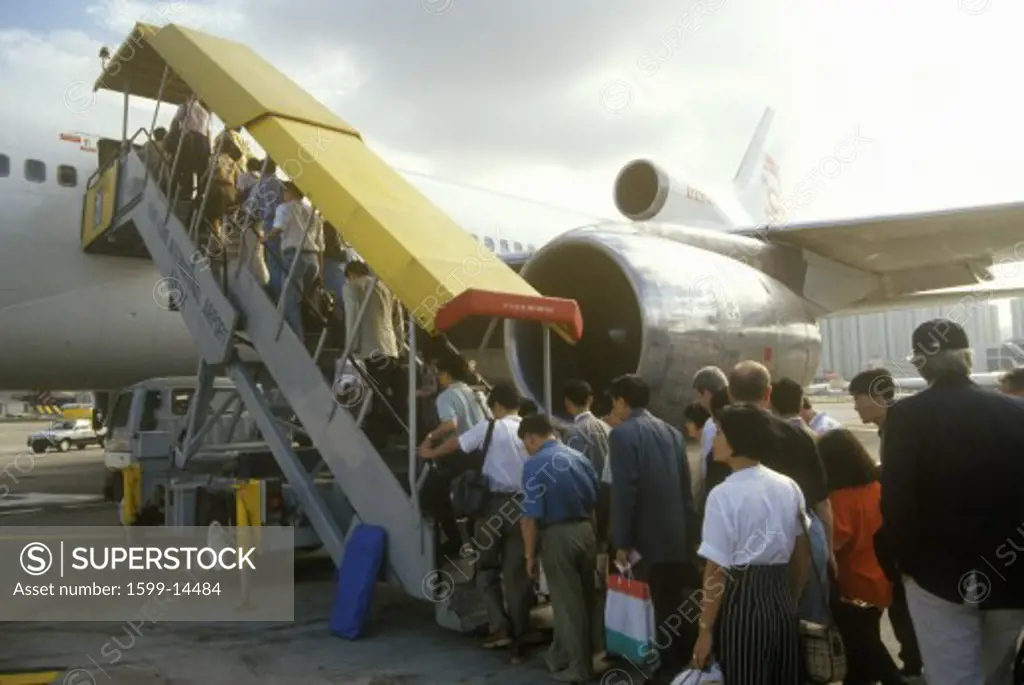 Executives boarding a passenger jet in Hong Kong